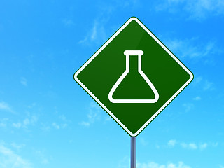 Image showing Science concept: Flask on road sign background