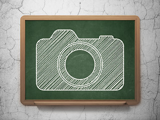 Image showing Travel concept: Photo Camera on chalkboard background