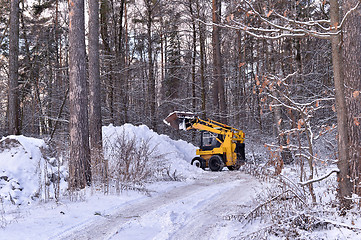 Image showing The tractor clears snow from the road