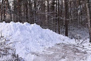 Image showing A pile of snow when clearing the road in the woods