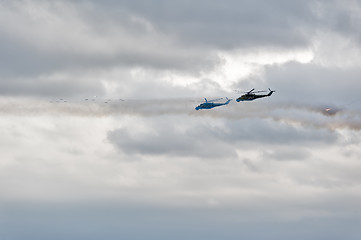 Image showing Helicopters MI-24 let out thermal traps and attack