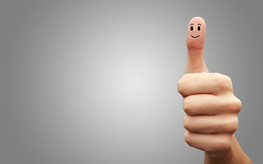 Image showing Happy cheerful smiley finger on grey background