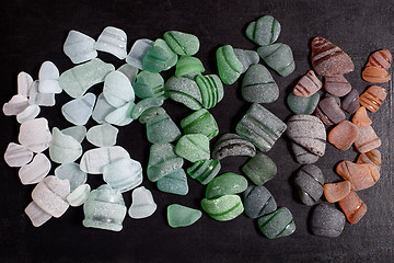 Image showing bottle necks glass pieces polished by the sea 