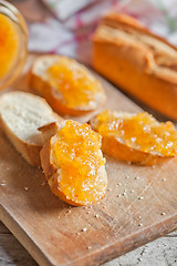 Image showing fresh bread with orange jam 