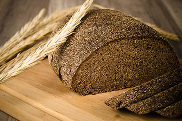 Image showing Black homemade bread and rye cones, close-up 