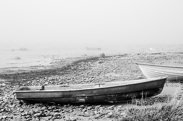 Image showing Old fishing boat at coast foggy in the morning