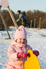 Image showing  Children swinging on a swing in winter