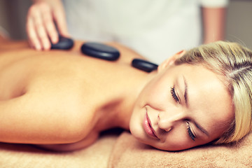 Image showing close up of woman having hot stone massage in spa