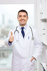 Image showing smiling doctor in white coat at medical office