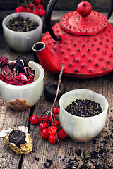 Image showing Assortment of custard and red tea kettle