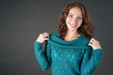 Image showing Attractive smiling red-haired womqn in sweater