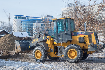 Image showing Tractor removes debris from building demolition