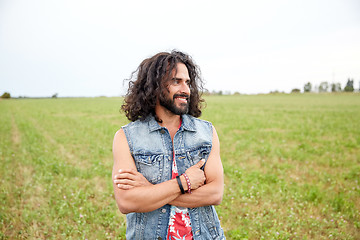 Image showing smiling young hippie man on green field