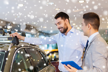 Image showing happy man with car dealer in auto show or salon