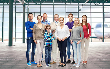 Image showing group of smiling people over airport terminal