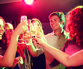 Image showing smiling friends with glasses of champagne in club