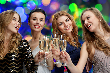 Image showing happy women clinking champagne glasses over lights