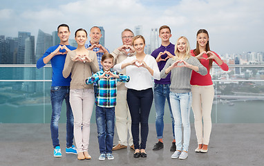 Image showing people showing heart hand sign over city waterside