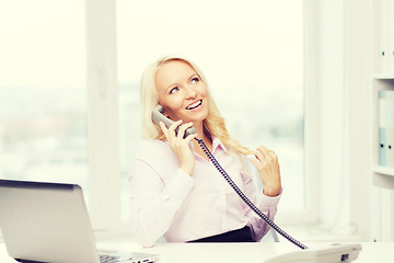 Image showing smiling businesswoman or student calling on phone