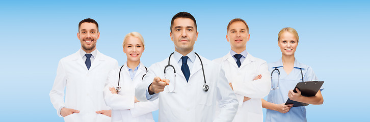 Image showing group of doctors with clipboard pointing at you