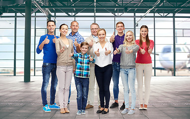 Image showing group of people showing thumbs up over airport