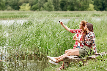 Image showing happy women taking selfie by smartphone outdoors