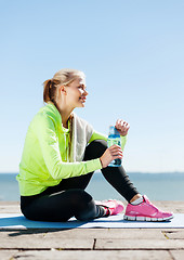 Image showing woman resting after doing sports outdoors