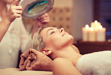 Image showing close up of young woman lying in spa