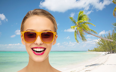 Image showing happy young woman in sunglasses with pink lipstick