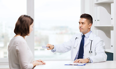 Image showing doctor giving pills to woman at hospital