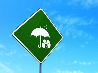 Image showing Safety concept: Family And Umbrella on road sign background