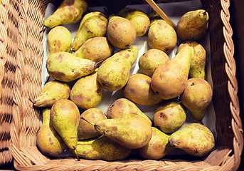 Image showing ripe pears in basket at food market or farm