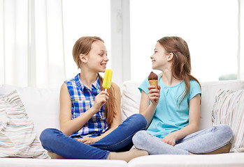 Image showing happy little girls eating ice-cream at home