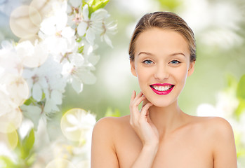 Image showing smiling young woman with pink lipstick on lips