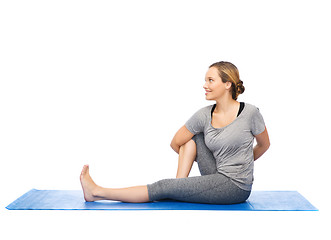 Image showing woman making yoga in twist pose on mat