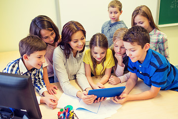 Image showing group of kids with teacher and tablet pc at school