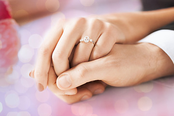 Image showing close up of couple hands with engagement ring