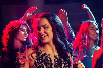 Image showing smiling friends with glasses of champagne in club