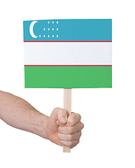 Image showing Hand holding small card - Flag of Uzbekistan