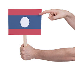 Image showing Hand holding small card - Flag of Laos