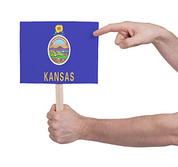 Image showing Hand holding small card - Flag of Kansas