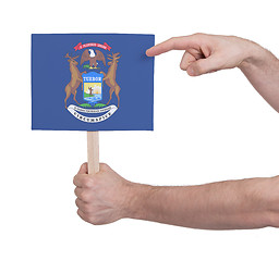Image showing Hand holding small card - Flag of Michigan