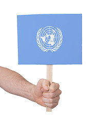 Image showing Hand holding small card - Flag of the UN