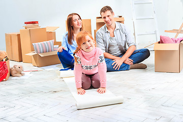 Image showing The happy family  at repair and relocation