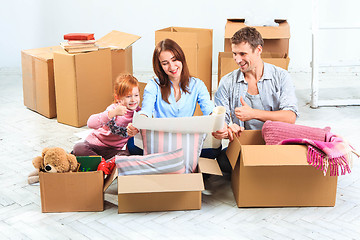 Image showing The happy family  during repair and relocation