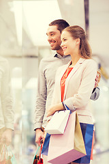 Image showing happy young couple with shopping bags in mall