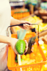 Image showing close up of woman with food basket in market