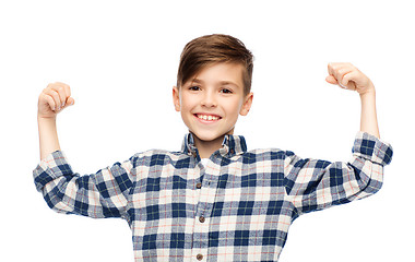 Image showing happy boy in checkered shirt showing strong fists