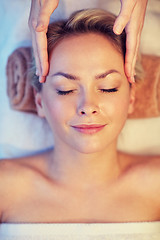 Image showing close up of woman having face massage in spa