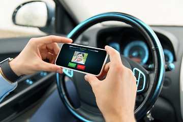 Image showing male hands with video call on smartphone in car